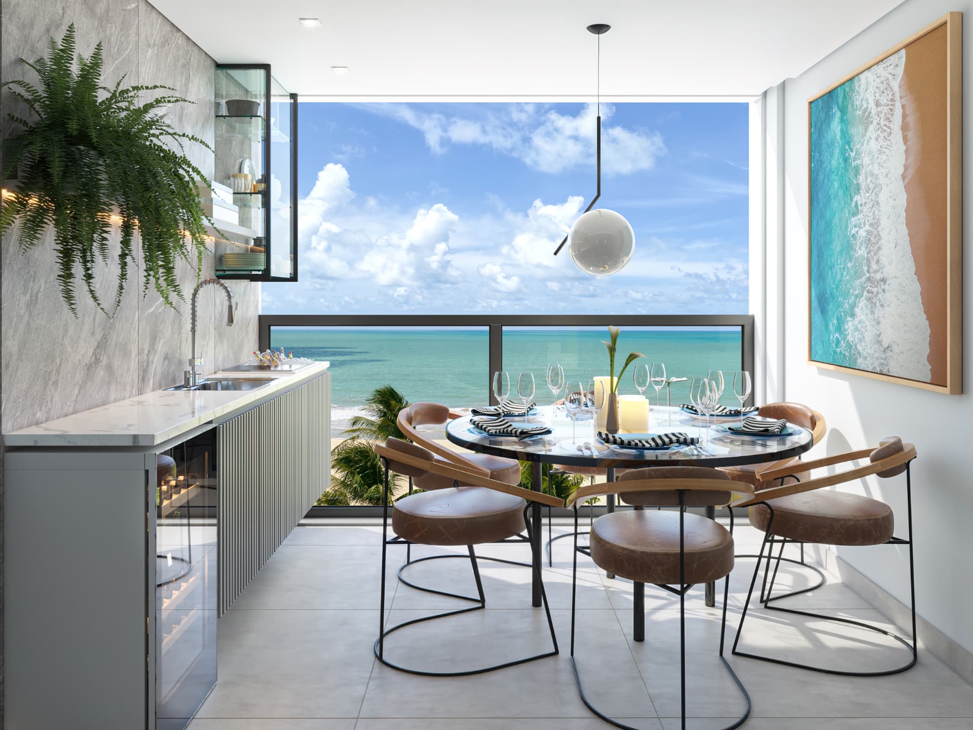 Varanda gourmet com bancada, mesa de jantar posta e vista frontal para o mar