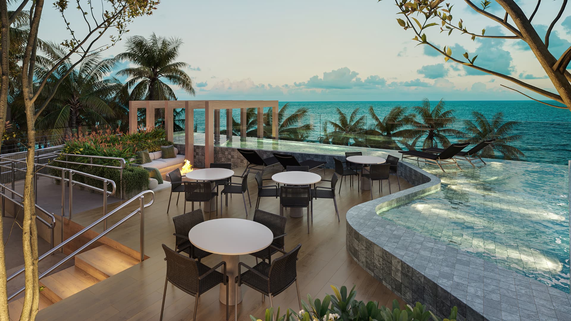 Piscina panorâmica com borda infinita voltada para o mar, com deck, mesas e espreguiçadeiras